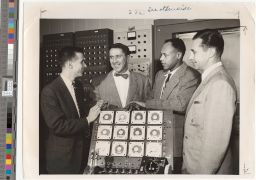 Dr. Meredith C. Gourdine with three other men, possibly at the Curtiss-Wright Aeronautical Labs.