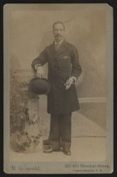 Man holding hat and cane