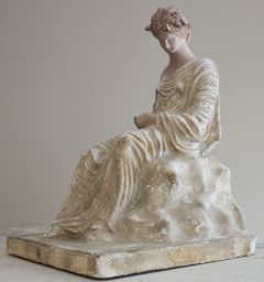 Figurine of a seated woman holding a fan