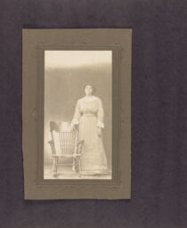 Portrait of a woman next to a rocking chair