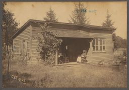 Woman in rocking chair on cabin porch